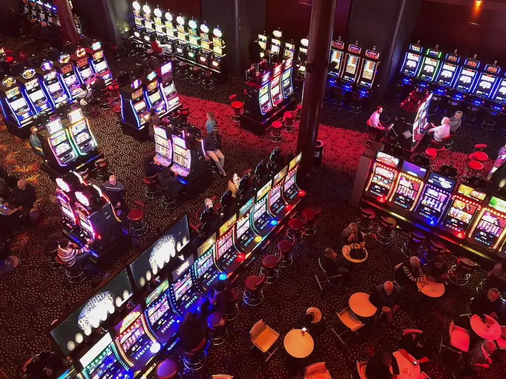 Aerial view of a casino floor with colorful slot machines and people playing